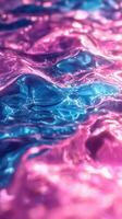 Waves of vibrant pink and blue hues create an abstract and mesmerizing water pattern in soft light photo