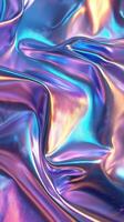 Elegant iridescent fabric draping in vivid purple and blue tones under soft light creating a luxurious atmosphere photo