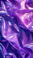 Colorful metallic fabric with vibrant purple and blue hues creating a reflective surface in artistic arrangement photo