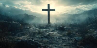 Cross stands in a misty landscape at dawn with a dramatic sky and rugged terrain surrounding it photo
