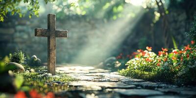 Serene garden path illuminated by sunlight and adorned with flowers and a stone cross among lush greenery photo