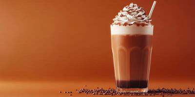 Creamy chocolate drink topped with whipped cream served in a tall glass on a warm orange background photo