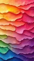 Colorful layered paper artwork showcasing a vibrant gradient of hues from warm tones to cool shades photo