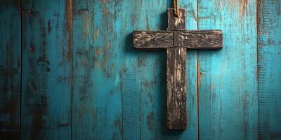 Rustic wooden cross against a vibrant teal wooden background in a serene setting photo