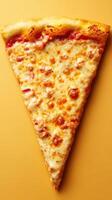 Sliced cheese pizza on a vibrant yellow background showing a close-up view of melted cheese and crispy crust photo