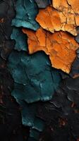 Colorful textured surface with orange and teal patches against a dark background photo