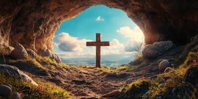 Wooden cross stands in a serene cave with a view of blue sky and rolling hills in the background during bright daylight photo