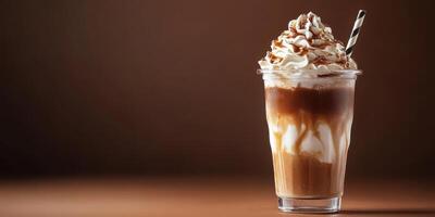 Delicious chocolate milkshake topped with whipped cream and chocolate drizzle served in a clear cup photo
