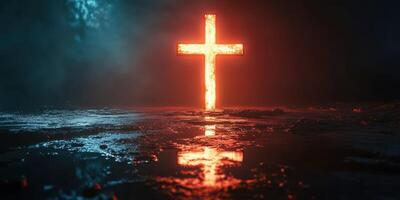 Illuminated cross in dark surroundings reflecting on wet surface during nighttime photo