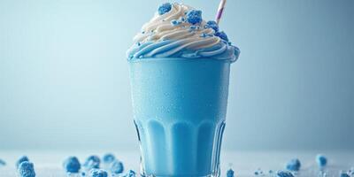Creamy blue beverage with whipped topping and sprinkles served in a glass on a light background photo