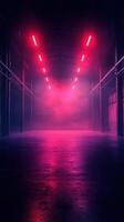 Bright pink neon lights illuminate a dark warehouse space filled with fog at night photo