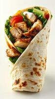 Grilled chicken wrap filled with fresh vegetables served on a clean white background photo