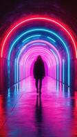 Walking through a vibrant neon tunnel illuminated with colorful lights at night in an urban setting photo