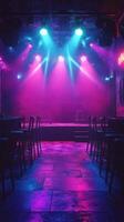 Neon lights illuminate an empty stage in a lively music venue ready for a performance photo