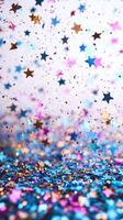 Colorful star-shaped confetti falls gracefully on a sparkling surface for a festive decoration photo