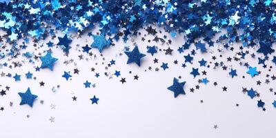 Sparkling blue and silver star confetti spread across a white surface in a festive celebration setting photo