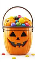 Halloween pumpkin bucket filled with colorful candy and decorative mini pumpkins photo