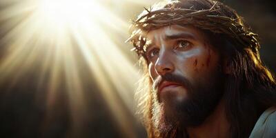 Man with crown of thorns gazes upward in a sunlit moment of reflection and sorrow in an ancient setting photo
