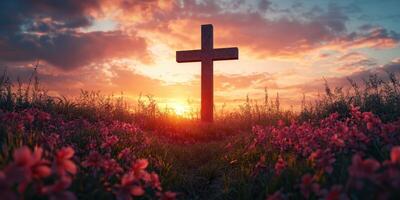 Sunset view of a wooden cross surrounded by vibrant flowers in a tranquil field photo