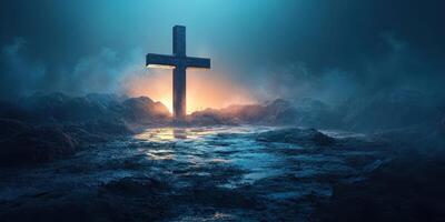 Cross illuminated by ambient light on a rocky landscape at dusk photo