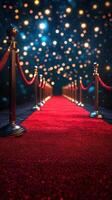 Elegant red carpet pathway leading to a glamorous event surrounded by twinkling lights at night photo