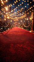Elegant red carpet pathway illuminated by string lights in a festive evening setting photo