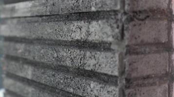 a close up of a brick wall with a black paint photo