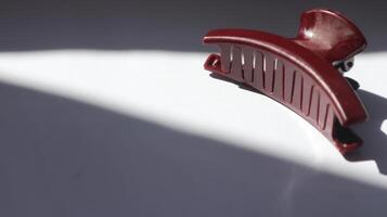 a red hair comb on a white surface photo