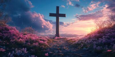 Cross standing in a field of pink flowers during a vibrant sunset with clouds illuminated by warm colors photo