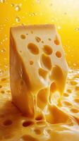 Cheese block melting on a vibrant yellow background with bubbles and a glossy texture photo