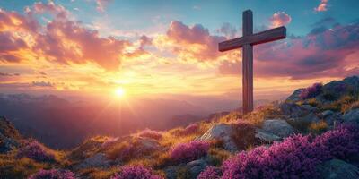 Beautiful sunset illuminating a wooden cross on a mountain with blooming flowers in the foreground photo