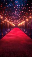 Elegant red carpet pathway lined with glowing lights and stanchions in a festive atmosphere photo