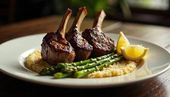 Grilled lamb chops served with asparagus, mashed potatoes, and a slice of lemon on an elegant plate. photo