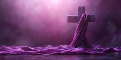 Wooden cross draped with purple cloth illuminated by soft light in a mystical setting photo