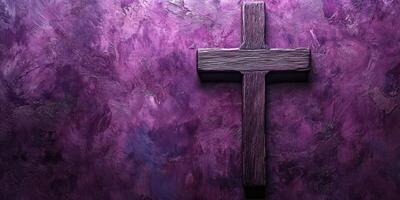 Wooden cross displayed against a purple textured wall in a serene setting for reflection and contemplation photo