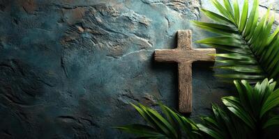 Wooden cross on textured wall surrounded by green palm leaves in a serene setting photo