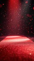 Bright red spotlight illuminates a glittering pathway in a dark space creating a dramatic atmosphere photo