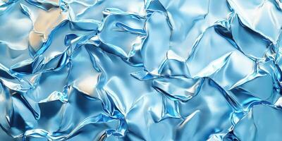 Crumpled shiny blue foil creating an abstract texture in natural light photo
