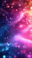 Colorful abstract texture features vibrant dots and shimmering light effects in a gradient from blue to pink photo