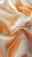 Elegant orange and white fabric folds create a soft, luxurious texture in natural light at a textile studio photo