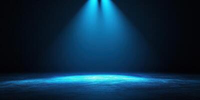 Bright blue spotlight illuminates empty stage in a darkened theater during a performance preparation photo