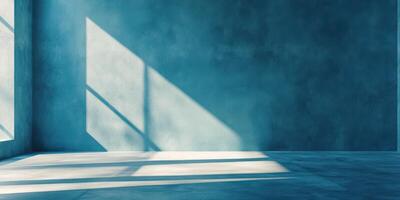 Light and shadow play in a minimalist room with textured blue walls and concrete flooring during daylight hours photo