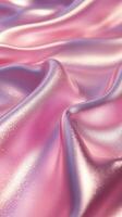 Shimmering pink and lavender silk fabric draped elegantly in soft waves creating a luxurious texture photo