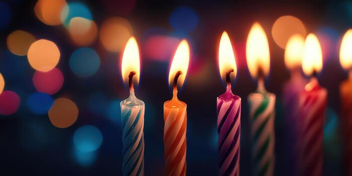 Colorful candles illuminate a festive gathering at night with vibrant bokeh lights in the background photo