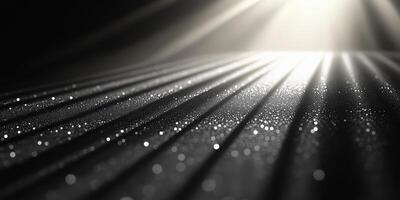 Light beams illuminate sparkling particles on a textured surface in a dark setting photo