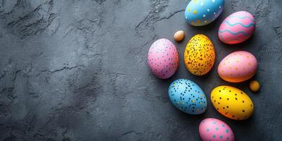 Brightly colored easter eggs arranged on a textured dark surface for festive spring celebration photo