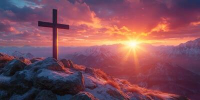 Sunrise over majestic mountains with a cross silhouetted against a vibrant sky photo