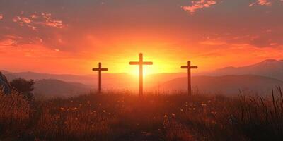 Three wooden crosses silhouetted against a vibrant sunset over mountain ranges photo