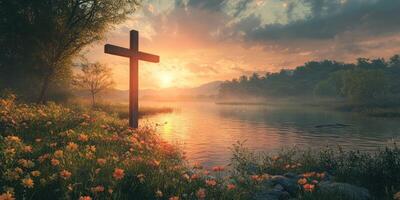Serene sunset at a lakeside with a wooden cross and blooming flowers in the foreground photo