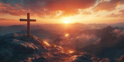 Sunrise over mountains with a wooden cross silhouetted on rocky terrain during early morning hours photo